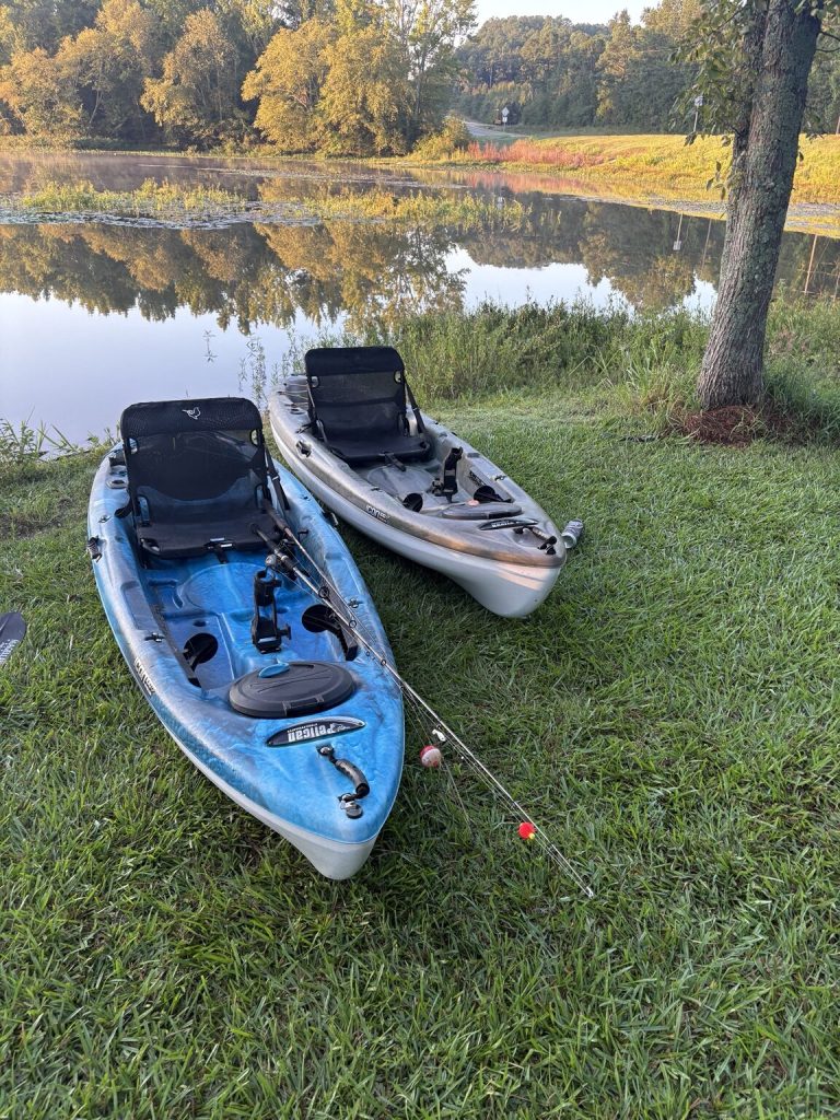 Two fishing kayaks prepared beside Beaverfork Lake in Conway, Arkansas, in the early morning