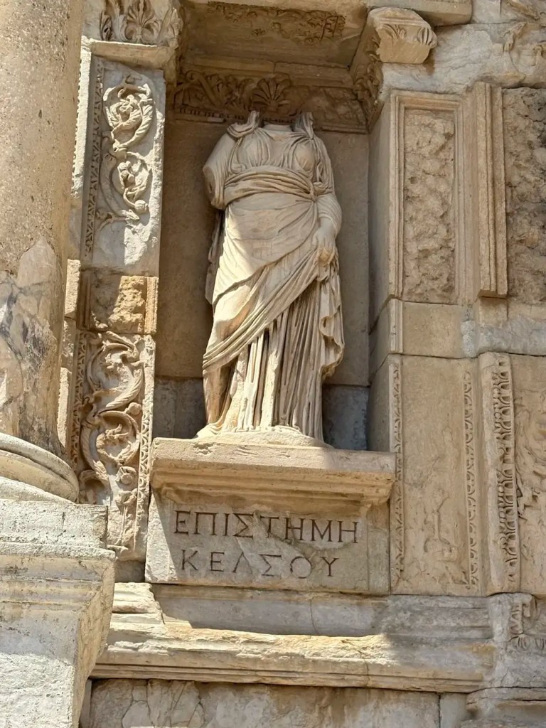 Carved marble figure and decorative stonework on the Library of Celsus facade at Ephesus