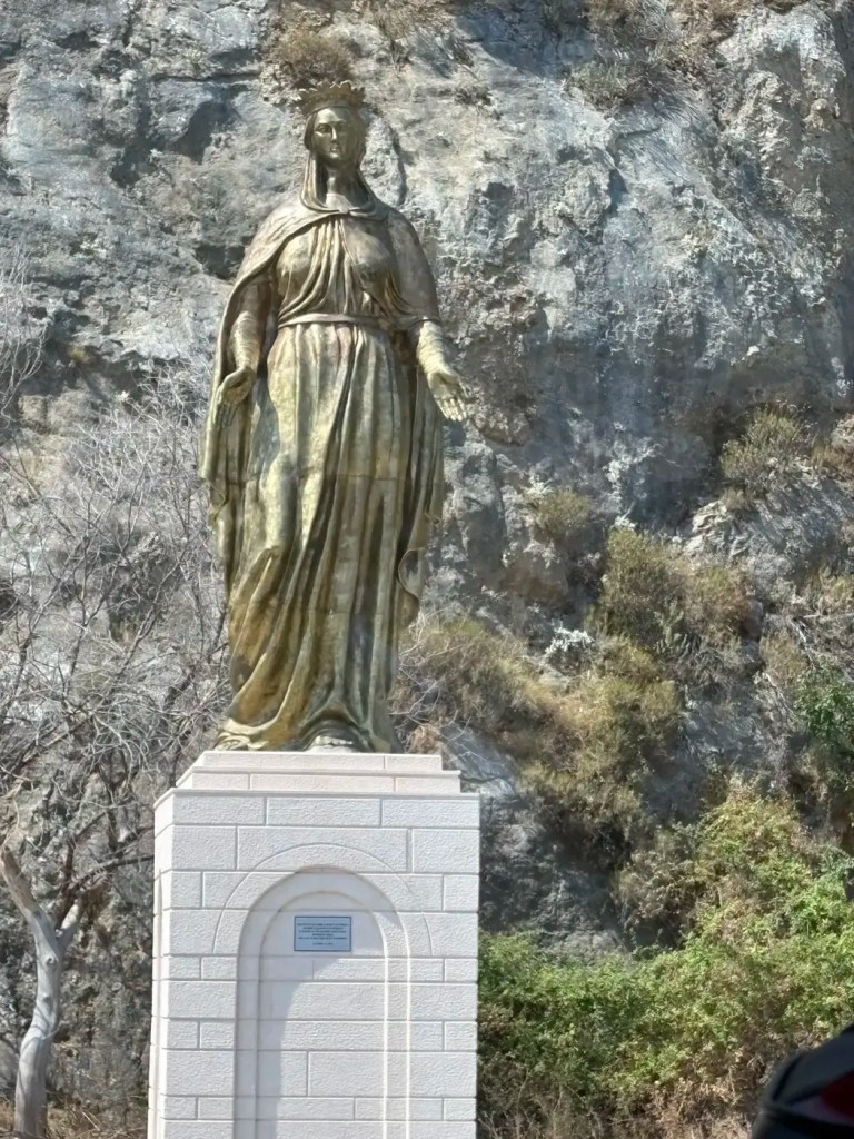 Tall statue of the Virgin Mary on a white pedestal near Ephesus