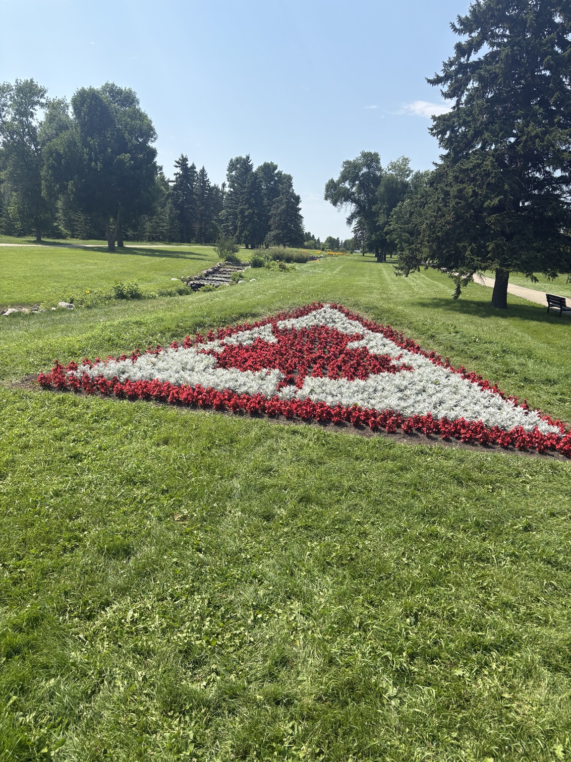 Red and white flowers form a Canadian flag in the International Peace Garden.