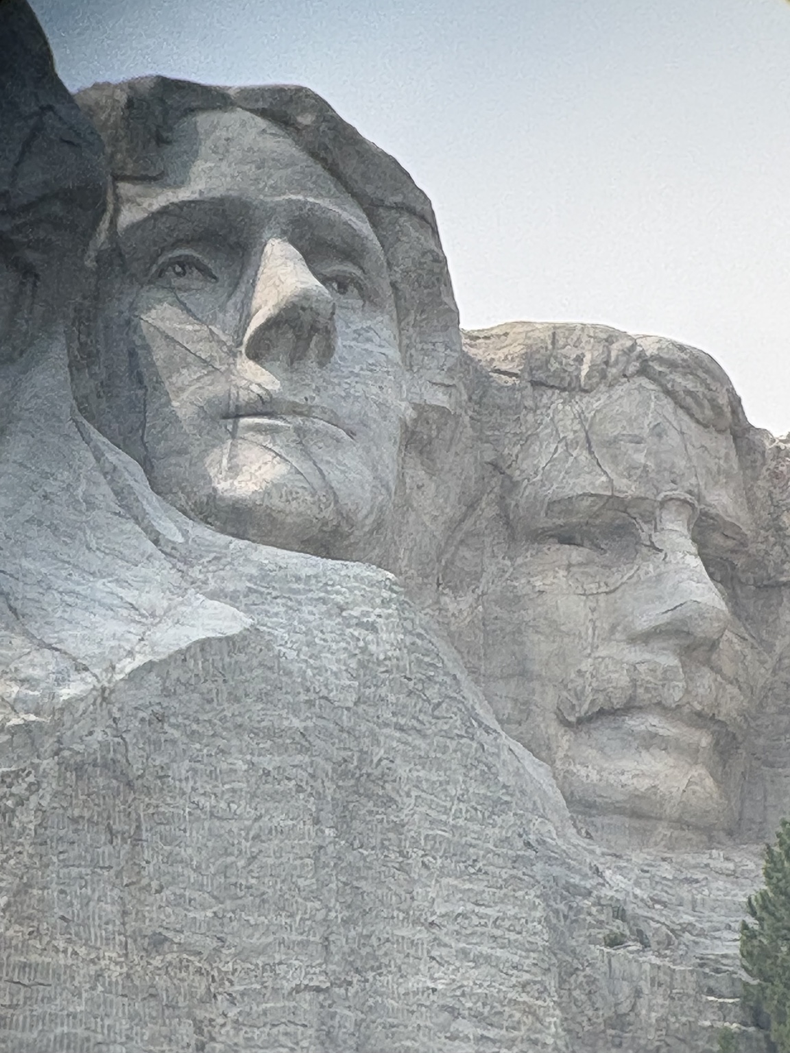 Close view of Thomas Jefferson and Theodore Roosevelt carved into Mount Rushmore.
